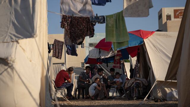 Palestinos desplazados por los ataques israelíes contra la Franja de Gaza sentados en un campamento del Programa de las Naciones Unidas para el Desarrollo en Jan Yunis, el 19 de octubre de 2023. (AP Foto/Fatima Shbair)