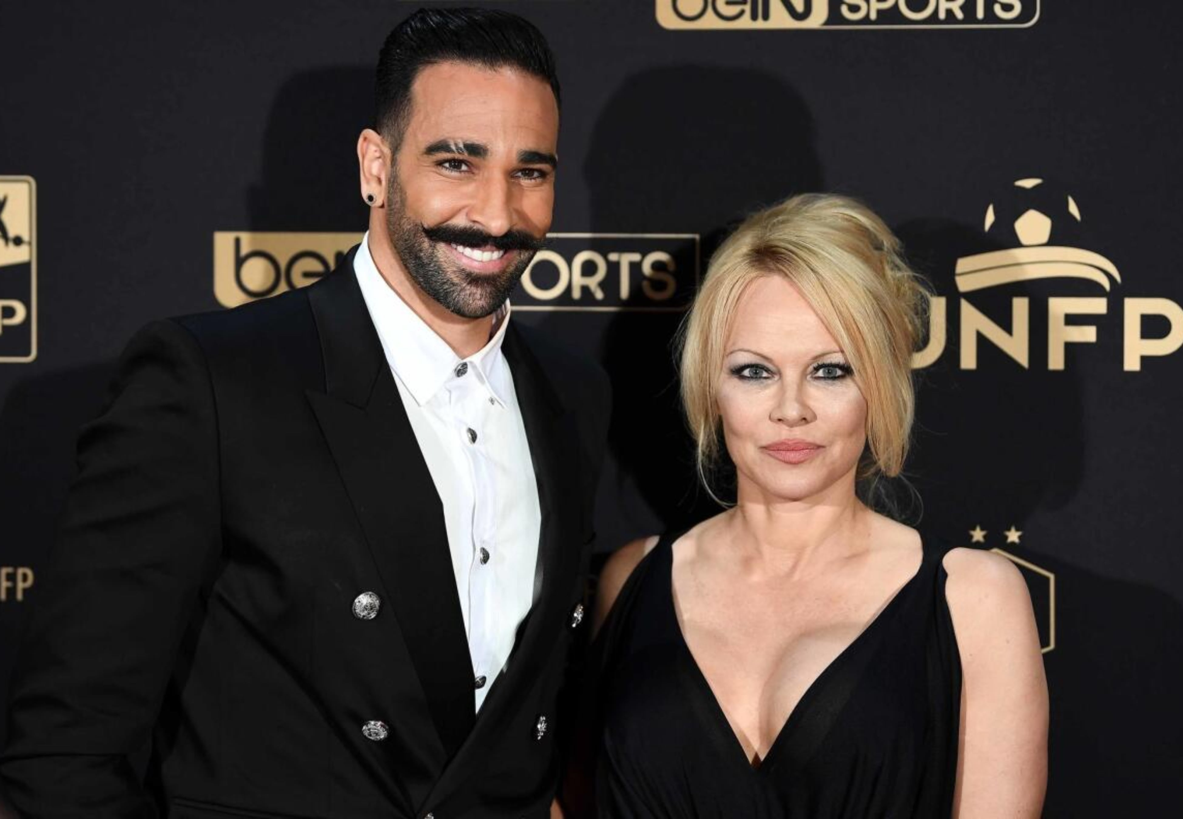 Anderson y el futbolista Adil Rami.