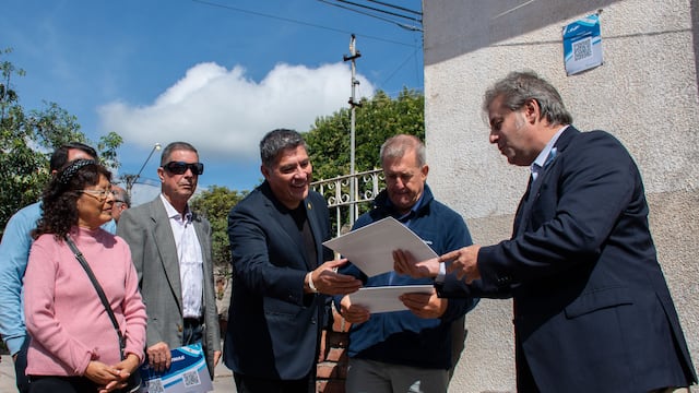 El concejal Millón muestra las placas QR y explica su contenido a los invitados especiales Guillermo Lobo y Jorge Barrionuevo, en el acto realizado en Alto Comedero.