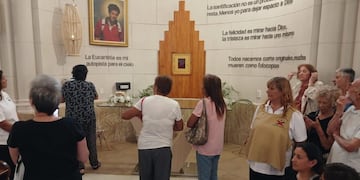 Peregrinos frente al altar en honor a Acutis en el templo de La Falda.