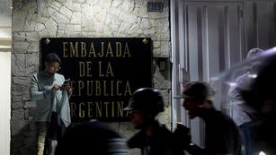 Partidarios de la oposición protestan por los resultados electorales oficiales frente a la embajada de Argentina. (AP)