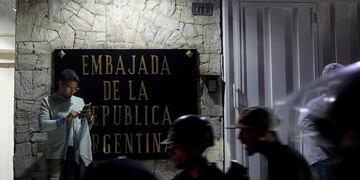 Partidarios de la oposición protestan por los resultados electorales oficiales frente a la embajada de Argentina. (AP)