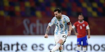Argentina's Lionel Messi scores his side's opening goal on a penalty kick during a qualifying soccer match against Chile for the FIFA World Cup Qatar 2022 in Santiago del Estero, Argentina, Thursday, June 3, 2021.