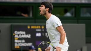 Carlos Alcaraz grita tras ganar un punto ante Novak Djokovic durante la final masculina de Wimbledon, el domingo 16 de julio de 2023, en Londres. (AP Foto/Kirsty Wigglesworth)