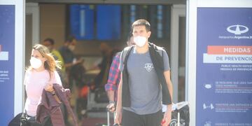 Pasajeros del último vuelo autorizado procedente del Reino Unido arriban al aeropuerto internacional de Ezeiza. (Clarín)