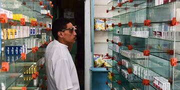 A worker of an empty pharmacy is pictured in Caracas on May 30, 2016\u002E\r\n The shortage of medicines in Venezuela exceeds 85%, revealed the president of the harmaceutical federation of Venezuela, Freddy Ceballos\u002E / AFP PHOTO / RONALDO SCHEMIDT venezuela caracas venezuela escasez de remedios en las farmacias crisis economica falta de medicamentos remedios farmacias