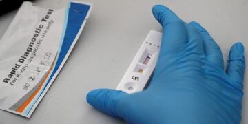 A health worker waits for the results of a quick test for the new coronavirus, being given to security guards assigned to the Miraflores district of Lima, Peru, Monday, April 13, 2020\u002E Each district, or neighborhood, operates with their own force of security guards, now concentrating on enforcing the government's orders for residents to stay home\u002E (AP Photo/Martin Mejia)