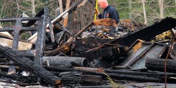 An Orland firefighter checks on burning hotspots Tuesday, Feb\u002E 5, 2019, in the rubble of a house that burned to the ground the night before, in Orland, Maine\u002E Investigators say a man died when he returned to the burning house to get his dog\u002E (Bill Trotter/The Bangor Daily News via AP)