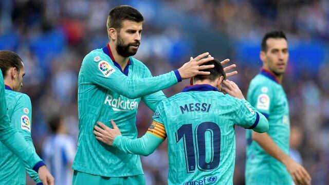 Barcelona's Gerard Pique, center left, congratulates Lionel Messi after he served teammate Luis Suarez to score their side's second goal during the Spanish La Liga soccer match between Real Sociedad and Barcelona, at Anoeta stadium, in San Sebastian, Spain, Saturday, Dec\u002E 14, 2019\u002E (AP Photo/Alvaro Barrientos)
