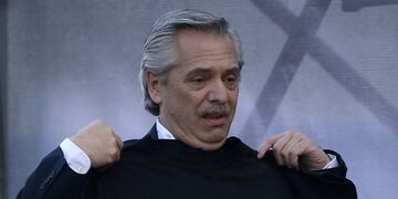 Argentina's presidential candidate for the Frente de Todos party, Alberto Fernandez, holds a jersey reading \