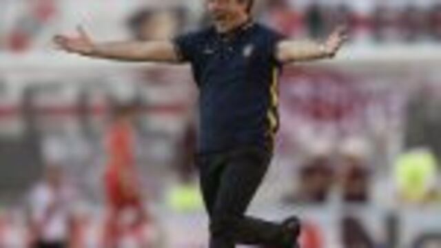 Boca Juniors' coach Guillermo Barros Schelotto celebrates after forward Ricardo Centurion (not in frame) scored the team's fourth goal against River Plate during their Argentine first division football match at the Monumental stadium in Buenos Aires, Arge