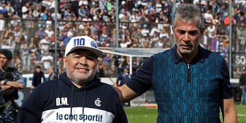 Argentine former football star Diego Armando Maradona walks with Gimasia president Gabriel Pellegrino (R) during the first training session of the team with him as coach at El Bosque stadium, in La Plata, Buenos Aires province, Argentina, on September 8, 2019\u002E (Photo by ALEJANDRO PAGNI / AFP)