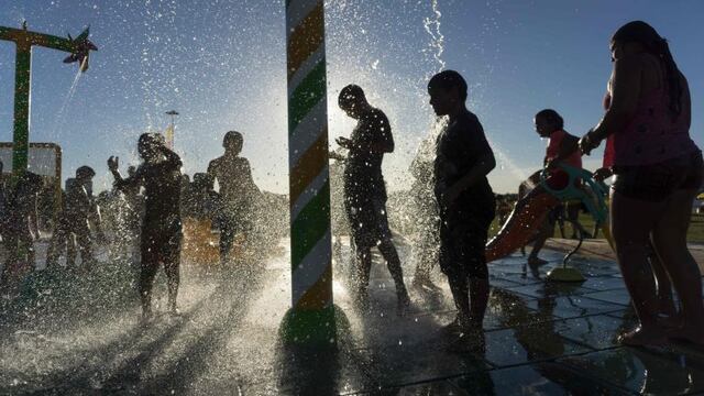 People sunbathe and cool off in the water at an artificial urban beach in Buenos Aires, on January 28, 2017. rnAs temperatures soar over 30c during the summer, portenos - as the residents of Buenos Aires are known - look for relief at artificial beaches o