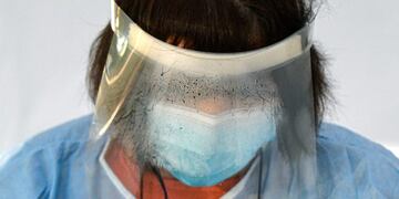A woman doing voters' triage, part of the measures against the spread of the COVID-19 infection, wears a steamy visor outside a station during local elections in Bucharest, Romania, Sunday, Sept\u002E 27, 2020\u002E Polls have opened in Romania’s municipal election, which is being seen as a test of how the next general election on Dec\u002E 6 will unfold for the country’s minority-led government\u002E (AP Photo/Andreea Alexandru)