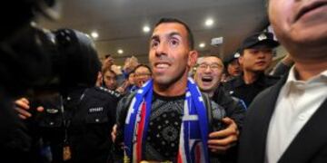 Argentine striker Carlos Tevez, center, arrives to fans and media at the Pudong International Airport in Shanghai on Thursday, Jan. 19, 2017. Shanghai Shenhua has recruited Tevez and has reportedly made the Argentine the highest-paid soccer player in the