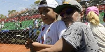 Argentina former footballer Diego Maradona poses with his grandson Benjamin Aguero (son of Gininna Maradona and footballer Sergio Aguero) after Italy's tennis player Paolo Lorenzi defeated by 6-3, 6-3, 6-3, Argentina's Guido Pella in their 2017 Davis Cup