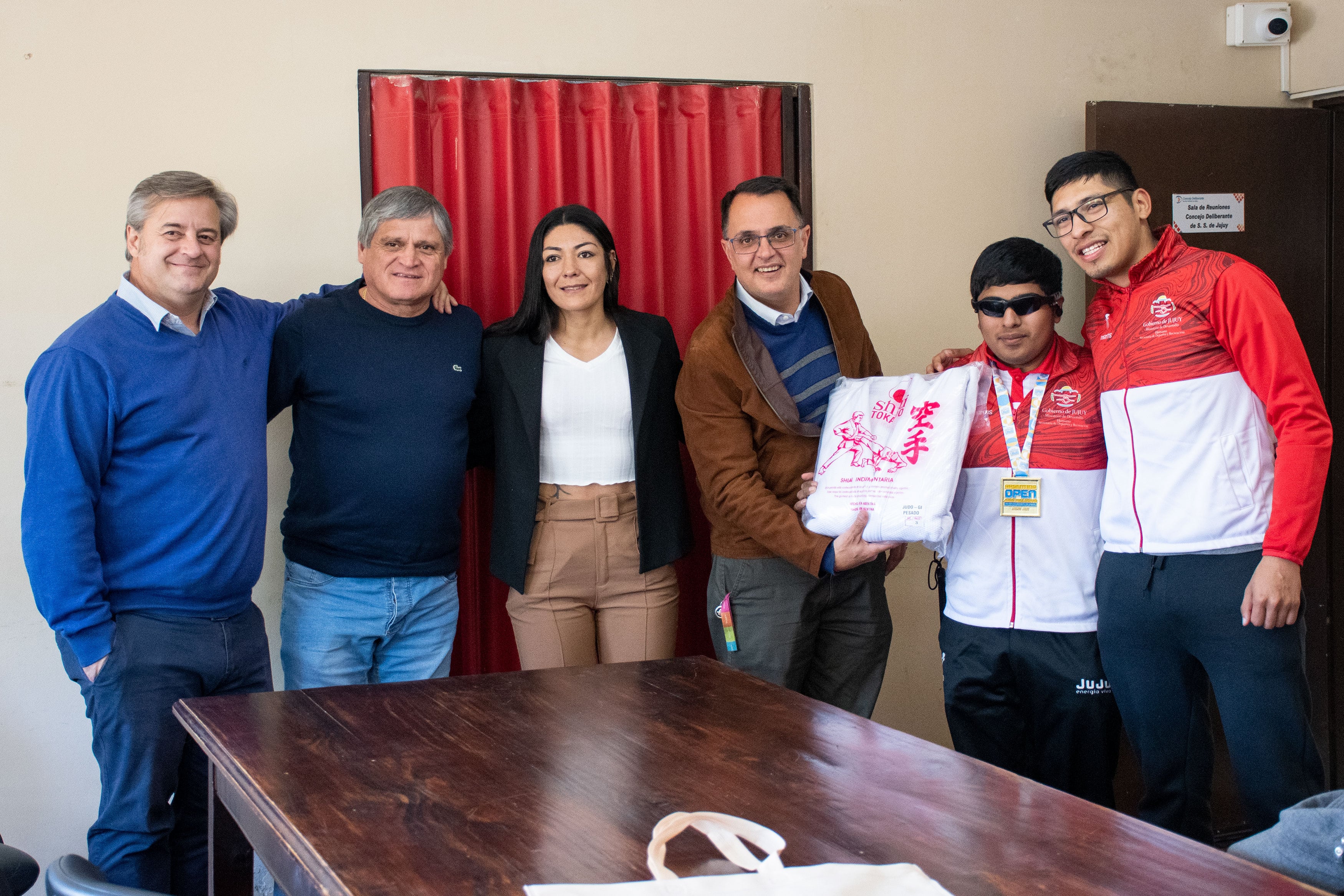 Los concejales Gastón Millón y Mario Lobo, la boxeadora y funcionaria municipal Brenda Carbajal, y el concejal Lisandro Aguiar, al momento de entregar la indumentaria al judoca José Emanuel Ávalos.