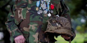 Argentine war veteran Jorge Altieri poses for a portrait with the blood-stained helmet, recently returned to him, that saved his life in 1982 during the Falklands war, in Buenos Aires, Argentina, Tuesday, March 12, 2019\u002E \