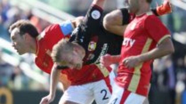 Joel Pohjanpalo of Bayer 04 Leverkusen is suppended by Leandro Desabato (L) and facundo Sanchez of Estudiantes de la Plata of Argentina while trying to score during the first half of the 2017 Florida Cup at Al Lang Stadium in St. Petersburg, Florida on Ja