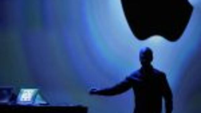 TOPSHOTS - Apple CEO Tim Cook reaches for iPhone as he speaks at Apple's Worldwide Developer Conference (WWDC) in San Francisco on June 10, 2013. Apple unveiled its hotly anticipated iTunes Radio Service, as the iconic maker of the iPhone moved to challen