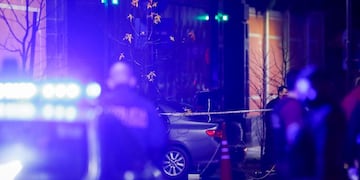 Police officers walk past a car which, according to local media, was crashed by a man into the exterior gate of the Chinese embassy in Buenos Aires, Argentina June 22, 2020\u002E REUTERS/Agustin Marcarian