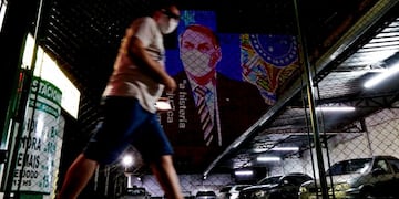 An image of Brazil's President Jair Bolsonaro wearing a protective face mask and the phrase “Hysteria Damages the Economy\
