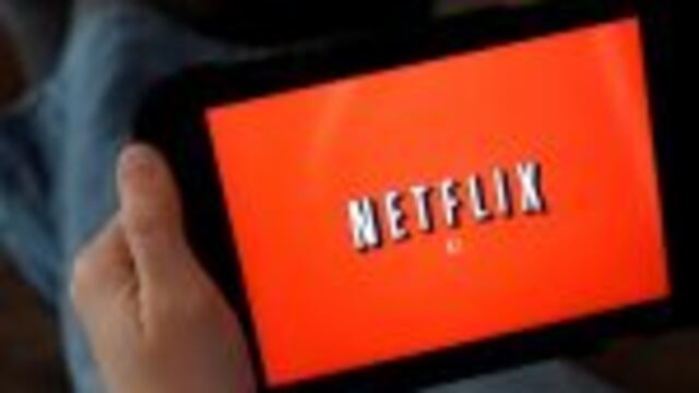 FILE - In this Friday, Jan. 17, 2014, file photo, a person displays Netflix on a tablet in North Andover, Mass. Netflix subscribers can now download shows and movies to watch later when theyu2019re not online, like during a flight or car. The download option