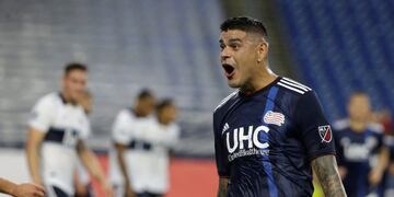 New England Revolution's Gustavo Bou, right, celebrates after scoring in the first half of an MLS soccer match against the Vancouver Whitecaps, Wednesday, July 17, 2019, in Foxborough, Mass\u002E (AP Photo/Steven Senne)