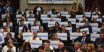 Handout photo released by the Argentinian Senate Press Office showing opposition legislators benches with banners reading \