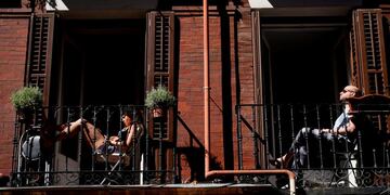 People sunbathe on their balconies, amid the coronavirus disease (COVID-19) outbreak in Madrid, Spain, May 20, 2020\u002E REUTERS/Juan Medina