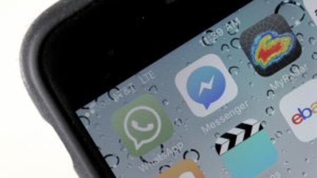 (FILES) This file photo taken on April 5, 2016 shows the WhatsApp application  displayed on a iPhone in San Anselmo, California. rnMobile messaging service WhatsApp on August 25, 2016 announced it would begin sharing subscriber data with parent Facebook,