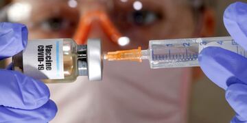 FILE PHOTO: A woman holds a small bottle labeled with a \