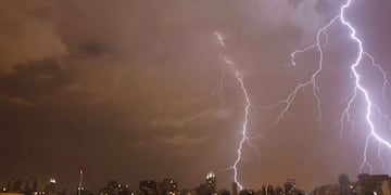 In this Jan. 1, 2014 photo, lightning strikes during a thunderstorm in Buenos Aires, Argentina. Argentines have suffered through a tough summer, with tropical rain that provided no relief from the heat and humidity, people having to throw out rotten food because of rolling power blackouts and soaring oil and gas prices, all amid rising inflation that is making it ever harder to reach the end of the month. The strain is evident on the faces of subway riders and others making their way home in Buenos Aires, where signs of poverty and decay are ubiquitous just beyond the glamorous streets where tourists go. (AP Photo/Rodrigo Abd) buenos aires  imagenes de la vida cotidiana en buenos aires clima tormentas electricas rayos