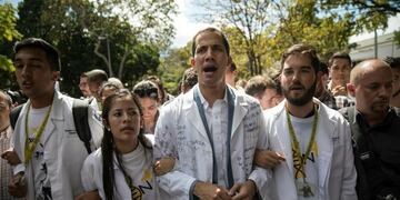 Opposition National Assembly President Juan Guaido, who declared himself interim president of Venezuela, takes part in a walk out against President Nicolas Maduro, in Caracas, Venezuela, Wednesday, Jan\u002E 30, 2019\u002E Venezuelans are exiting their homes and workplaces in a walkout organized by the opposition to demand that Maduro leave power\u002E (AP Photo/Rodrigo Abd)