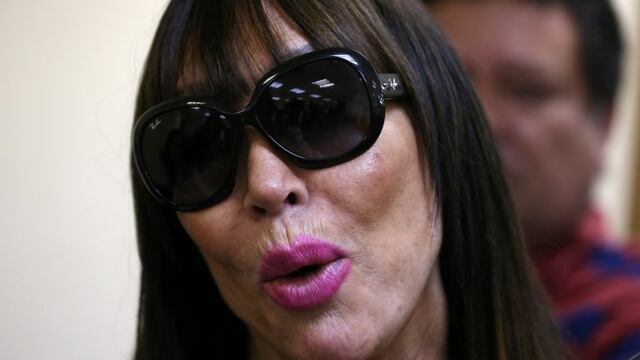 Argentina's Ana Maria Casanova, better known as Moria Casan, talks to journalists after she was freed from prison in Luque, Paraguay, Wednesday, Dec. 23, 2015. The actress had been accused of keeping jewelry worth $80,000 that she'd been loaned for a 2012