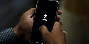 FILE - In this July 21, 2020 file photo, a man opens social media app 'TikTok' on his cell phone, in Islamabad, Pakistan\u002E The owner of TikTok has chosen Oracle over Microsoft as the American tech partner that could help keep the popular video-sharing app running in the U\u002ES\u002E, according to a source familiar with the deal who was not authorized to speak publicly about it\u002E (AP Photo/Anjum Naveed, File)