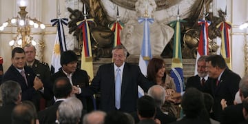 (FILES) In this file picture taken on December 9, 2007 (L-R) Presidents Rafael Correa of Ecuador, Evo Morales of Bolivia, Nestor Kirchner of Argentina and his wife president-elect Cristina Fernandez, Luiz Inacio Lula da Silva of Brazil, Nicanor Duarte of Paraguay and Hugo Chavez of Venezuela, hold hands after the signing the launching of the Bank of the South, during a ceremony at the presidential palace in Buenos Aires\u002E - Bolivian President Evo Morales resigned on November 10, 2019, caving in following three weeks of sometimes-violent protests over his disputed re-election after the army and police withdrew their backing\u002E (Photo by Juan MABROMATA / AFP)