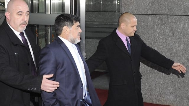 Former Argentiniar football player Diego Armando Maradona (C) leaves the Mirasierra Hotel with a security detail on February 15, 2017 after speaking with Spanish police who were contacted by concerned staff over an argument between Maradona and his girlfr