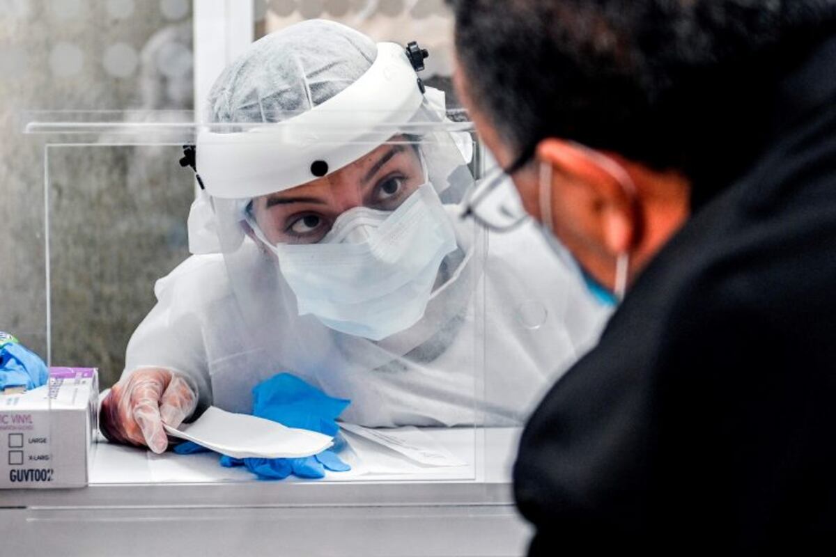 A health worker speaks with a man during a random COVID-19 testing at a Metro station, amid the coronavirus pandemic, in Medellin, Colombia on July 6, 2020\u002E (Photo by JOAQUIN SARMIENTO / AFP)