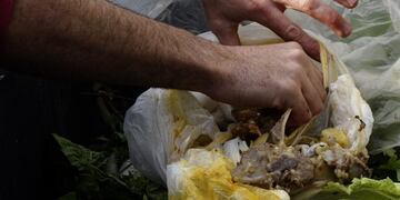 hombre buscando alimentos comida en la basurarnrnTO GO WITH AFP HISTORY BY LILIANA SAMUELrnAriel Rodriguez Bosio, 34, promoter of the