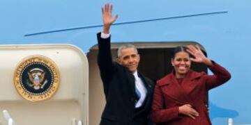 Former President Barack Obama and his wife Michelle wave to the crowd as they board an Air Force jet to depart Andrews Air Force base in Andrews Air Force Base, Md., Friday, Jan. 20, 2017. (AP Photo/Steve Helber)