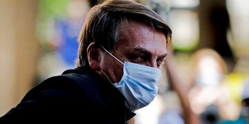 Brazilian President Jair Bolsonaro is seen as he visits the residence of an adviser in Brasília, on August 23, 2020\u002E - Bolsonaro on Sunday threatened to punch a reporter repeatedly in the mouth after being asked about his wife's links to an alleged corruption scheme\u002E \