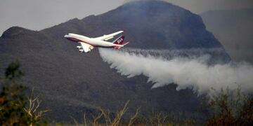 TOPSHOT - View of a Supertanker, an aerial firefighting airtanker, overflying the fires raging near Robore, Santa Cruz region, eastern Bolivia on August 23, 2019\u002E - The outbreaks of fire, which have razed around 750,000 hectares of forest and crops, were caused by the burning of crop fields, the Heat Focus Monitoring Office of the Forest and Land Authority (ABT) said earlier this week\u002E (Photo by STR / AFP)