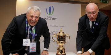 Claude Atcher Director of the French World Cup bid, left, and Bernard Laporte, President of the French Rugby Union pose for photographs after France won the right to host Rugby World Cup in 2023, with the Rugby World Cup trophy at a hotel in London, Wednesday, Nov\u002E 15, 2017\u002E Three competing countries South Africa, Ireland and France bid for the rights to hold the RWC in 2023, following the next RWC which will be held in Japan in 2019\u002E(AP Photo/Alastair Grant)