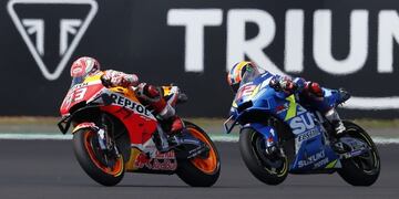 Repsol Honda Team's Spanish rider Marc Marquez (L) leads Suzuki Ecstar's Spanish rider Alex Rins (R) during the Moto GP race of the British Grand Prix at Silverstone circuit in Northamptonshire, central England, on August 25, 2019\u002E - Alex Rins won the British MotoGP in dramatic fashion as the Team Suzuki rider pipped world champion Marc Marquez to the finish line by 0\u002E013 seconds at Silverstone on Sunday\u002E (Photo by Adrian DENNIS / AFP)