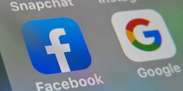 (FILES) In this file photo taken on October 1, 2019 in Lille shows the logos of mobile apps Facebook and Google displayed on a tablet\u002E - Facebook on October 3, 2019 launched Threads, an image-centric messaging app designed to weave tight circles of Instagram friends together, while ramping up its challenge to rival Snapchat\u002E Threads is its own separate smartphone app, but ties into lists of \