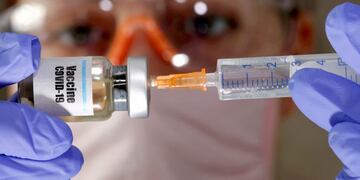 FILE PHOTO: A woman holds a small bottle labeled with a \