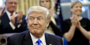 U.S. President Donald Trump smiles after signing executive orders related to a lobbying ban in the Oval Office of the White House in Washington, D.C., U.S., on Saturday, Jan. 28, 2017. Trump moved to reorganize his National Security Council, implement a lobbying ban for political appointees once they exit his administration, and order the Pentagon to create a plan to defeat the Islamic State terror organization. Photographer: Pete Marovich/Pool via Bloomberg