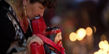 In this Nov\u002E 8, 2014 photo, a woman leans on a statue of popular folk saint Gauchito Gil at a sanctuary built in his honor by people who attribute miracles to him, on the anniversary of his death in Alejandro Korn, Argentina\u002E Gauchito Gil was an 1800's outlaw who has become a symbol of bravery, stealing from the rich and giving to the poor\u002E He was born Antonio Mamerto Gil Nunez in the 1840's, and executed on Jan\u002E 8, 1878\u002E People build altars in his name across the nation where on every 8th of the month, they gather to pay him tribute\u002E (AP Photo/Natacha Pisarenko) alejandro Korn  religion catolica santos Gauchito Gil aniversario muerte santo ritos religion catolica santos populares