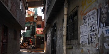 A man stands with his bicycle at Padre Carlos Mugica neighborhood, also known as Villa 31 shantytown, during the lockdown imposed by the government against the spread of the new coronavirus, COVID-19, in Buenos Aires, on May 18, 2020\u002E - The Crisis Committee of Villa 31 gave a press conference to demand that the health emergency be declared immediately in Buenos Aires as a result of the alarming progress of the novel coronavirus\u002E (Photo by JUAN MABROMATA / AFP)